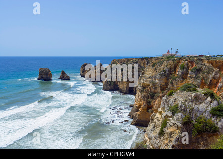 View along the coast from Ponta da Piedade with the Ponta da Piedade Lighthouse to the right, near Lagos, Algarve, Portugal Stock Photo