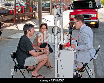 Passersby stop at the portable 'Homeless Museum of Art' on a sidewalk the lower west side of Manhattan, New York City Stock Photo