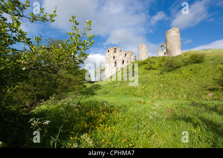 View from the riverbank of the round towers of Norman Clun Castle Stock Photo