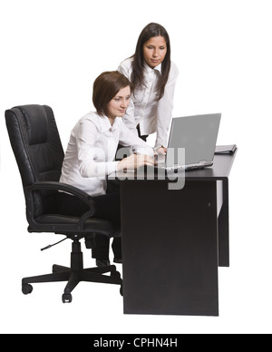 Two young businesswoman working together on a laptop at their office desk. Stock Photo