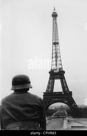 German Soldier in Front of the Eiffel Tower, 1940 Stock Photo