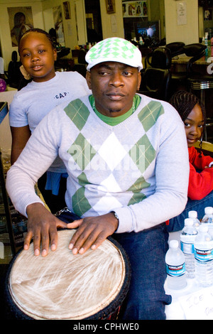African American man playing conga drum with youngsters listening. Mexican Independence Day Minneapolis Minnesota MN USA Stock Photo