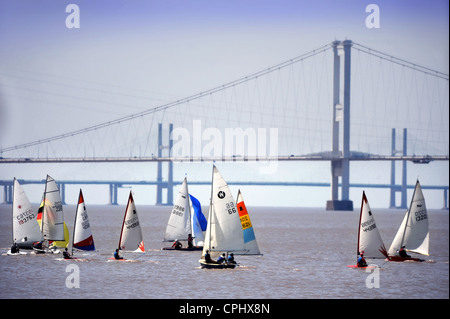 Sailers at a regatta on the River Severn estuary with the first Severn Bridge nearest and second Severn crossing in the distance Stock Photo