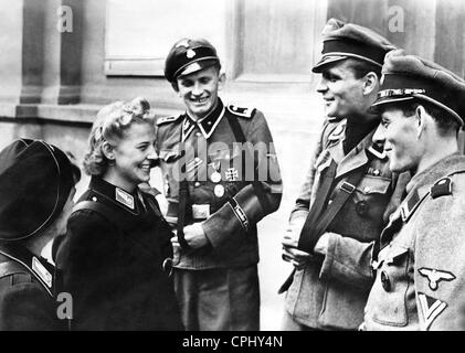 Soldiers of the Waffen-SS in conversation with female tram assistants, 1944 Stock Photo