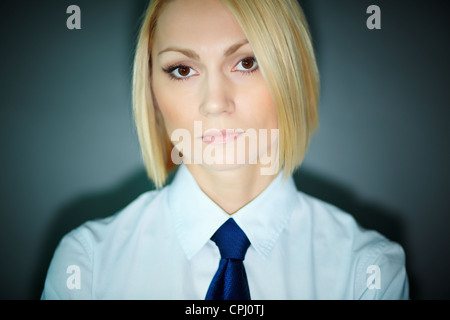 Portrait of serious blonde woman looking at camera