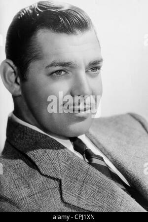 CLARK GABLE (1901-1960) American film actor stands beside a B-17 Flying ...