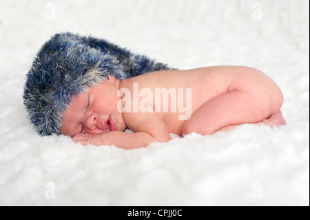 top view of sleeping newborn baby with hat Stock Photo