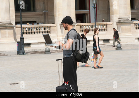 Paris, France - Man using a laptop on the streets Stock Photo