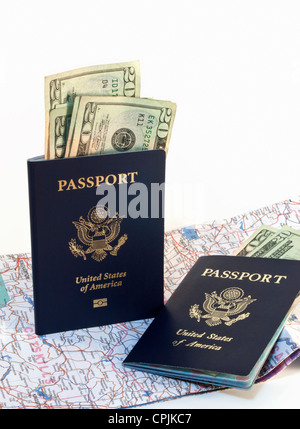 Two American passports with paper money and open map isolated on white background. Stock Photo