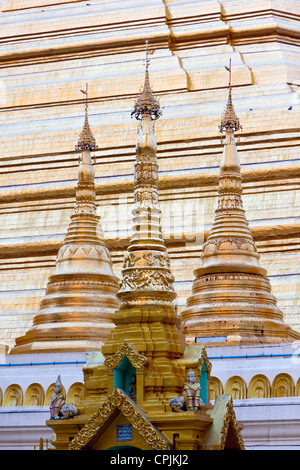 Myanmar, Burma. Shwedagon Pagoda, Yangon, Rangoon. Small Pagodas in foreground, base of main pagoda behind. Stock Photo