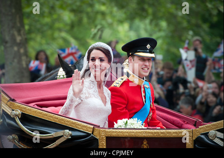 Prince William and Catherine Middleton ride in a carriage down The Mall after their marriage at Westminster Abbey. Stock Photo
