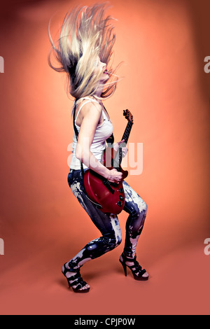 portrait of young woman with a guitar on the stage Stock Photo