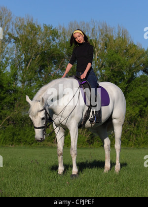Beautiful asian woman riding a white horse Stock Photo