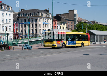 An Irisbus single deck bus operated by TEC arrives at the bus station outside Charleroi South station. Stock Photo