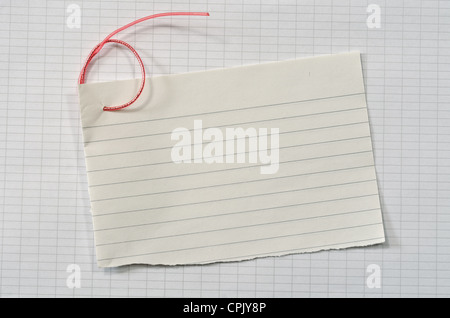 torn lined paper with red wire in shape of number six over data paper sheet, horizontal shot Stock Photo