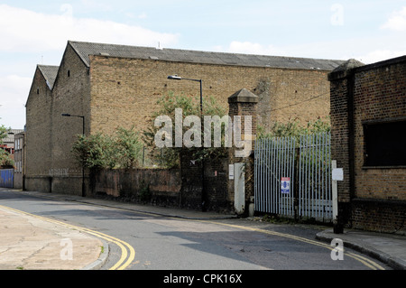Gates to derelict factory, Orchard Place, Blackwall, Leamouth Peninsular, Poplar, Tower Hamlets, East London, England UK Stock Photo