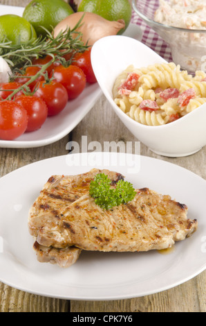 grilled pork chops with noodle salad on a plate Stock Photo