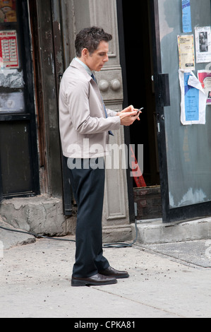 Ben Stiller who is directing and starring in The Secret Life of Walter Mitty seen here checking video he has shot on his mobile Stock Photo