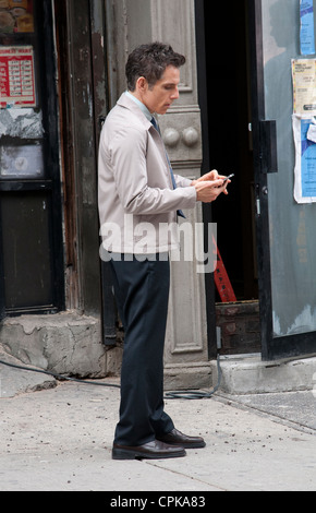 Ben Stiller who is directing and starring in The Secret Life of Walter Mitty seen here checking video he has shot on his mobile Stock Photo