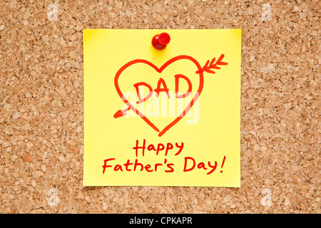 Sticky note with Happy Fathers Day on a cork bulletin board. Stock Photo