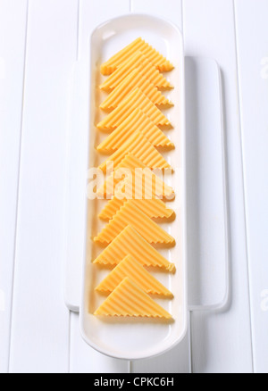 Hard cheese cut into triangles Stock Photo