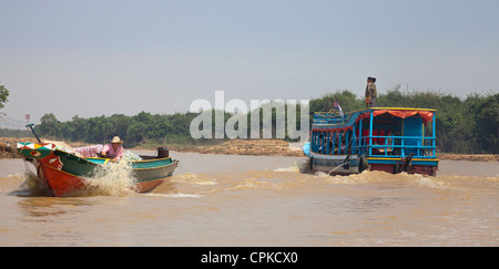 Tonle Sap Lake, Siem Reap, Cambodia. Speed boat and ferry with children riding on the roof. Stock Photo