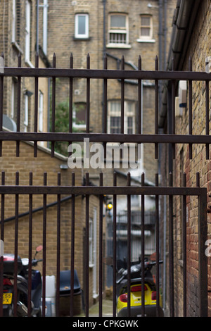 Metal gates in residential back street entrance in Brixton Stock Photo