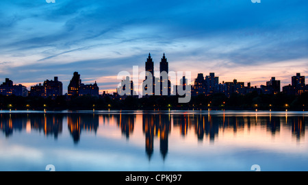 Skyline of buildings along Central Park West viewed from above Jackie Kennedy Onassis Reservoir in New York City. Stock Photo