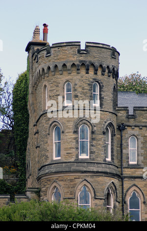 Exterior of historical house with turret, blue sky background. Stock Photo