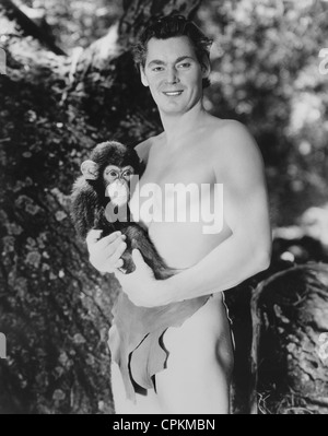 A black and white portrait of the film star Johnny Weismuller taken in Los Angeles in 1939. He is filming with Cheetah. Stock Photo