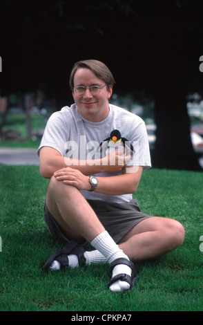 Linux inventor Linus Torvalds holds “Tux” a penguin character that is the  mascot of Linux open source software. Stock Photo