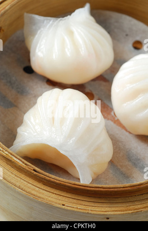 Dim Sum or Chinese dumpling in a stream hot pot of food wheelbarrow on  street food of Bangkok. Many dumpling in a wooden basket is streaming in  old As Stock Photo 