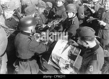 Soldiers Read the 'Westfront-Illustrierte' in Occupied France, 1940 Stock Photo
