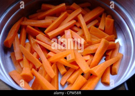 Fresh carrots washed and batoned in a colander Stock Photo