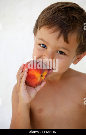 CHILD EATING FRUIT Stock Photo