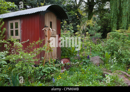 Shepherds hut in a wildflower garden for staycation glamping in the UK Stock Photo