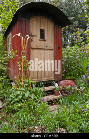 Shepherds hut in a wildflower garden for staycation glamping in the UK Stock Photo