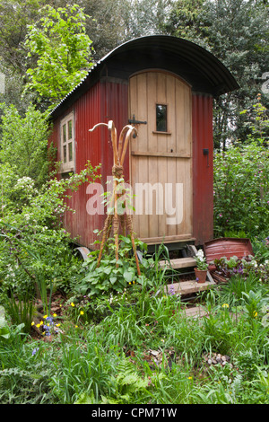 Shepherds hut in a wildflower garden for staycation glamping in the UK Stock Photo