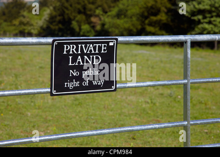 Farm gate with 'Private Land' sign. Stock Photo