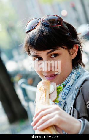 WOMAN EATING A SANDWICH Stock Photo