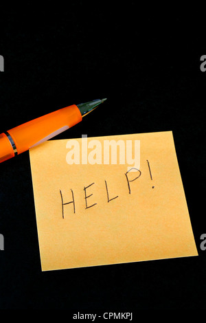 We need your help message written on ripped torn paper piece on pink ...