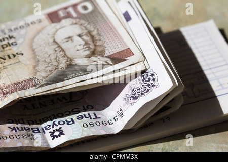Scottish bank notes with Bank pay in book for small business.. UK Stock Photo