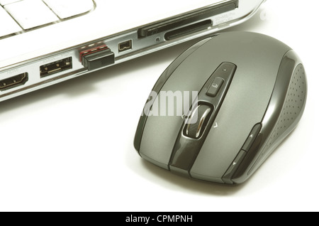 Black laser mouse near a white notebook Stock Photo