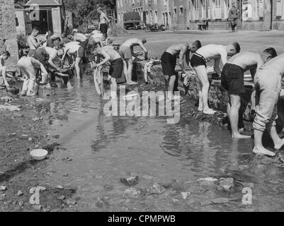 German soldiers washing their laundry in a French town Stock Photo
