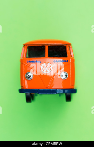 Orange Matchbox Die cast Volkswagen van on green background Stock Photo