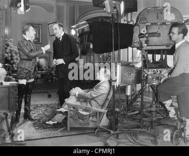 Adolphe Menjou, Ernest Torrence and Harry Beaumont while shooting, 1931 Stock Photo