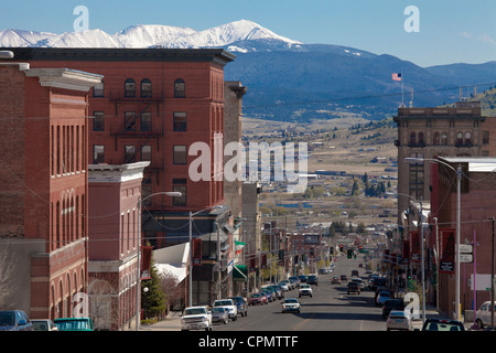 Main Street in business district of Butte, Montana, with a range of the Rocky Mountains snowcapped in the distance. Stock Photo