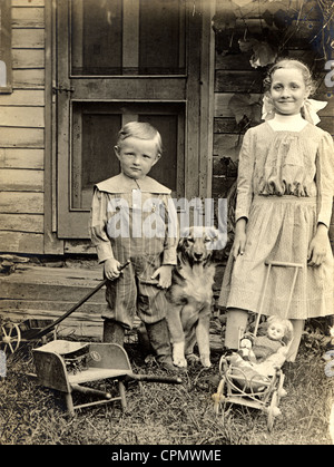 Little Brother & Big Sister with Toys & Dog Stock Photo