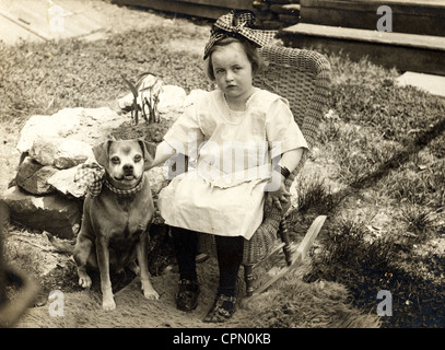 Little Girl & Small Dog Wearing Matching Bows Stock Photo