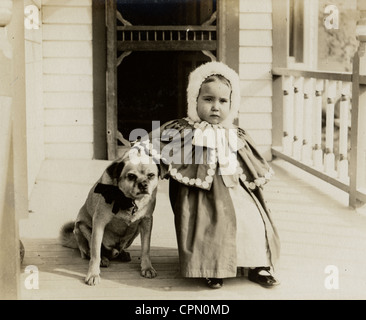 Cute Little Girl with Pug Dog on the Porch Stock Photo